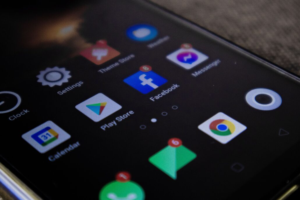 Detailed view of a smartphone screen with popular app icons including Facebook and Messenger.