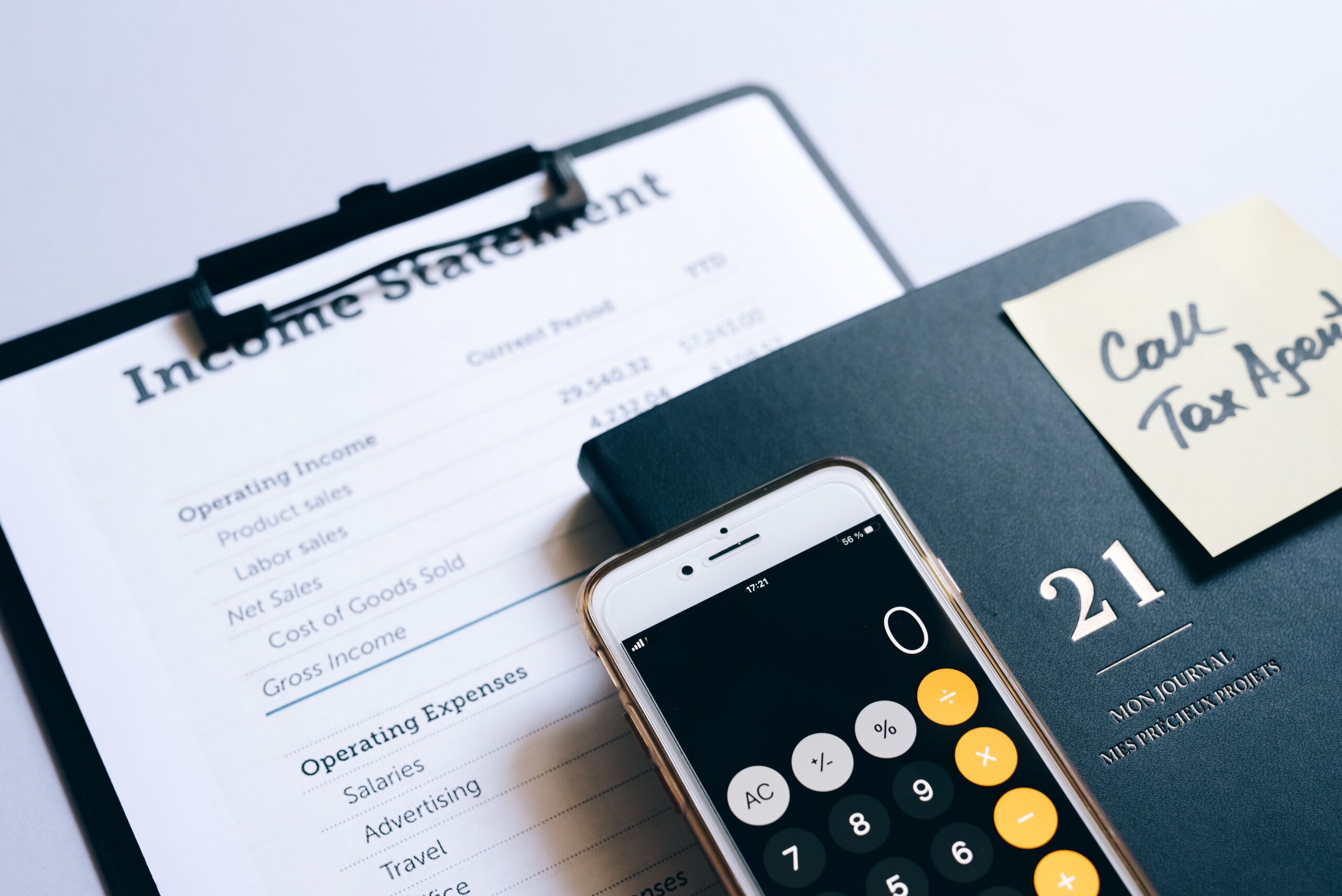 Close-up of income statement, calculator, and planner for financial planning.